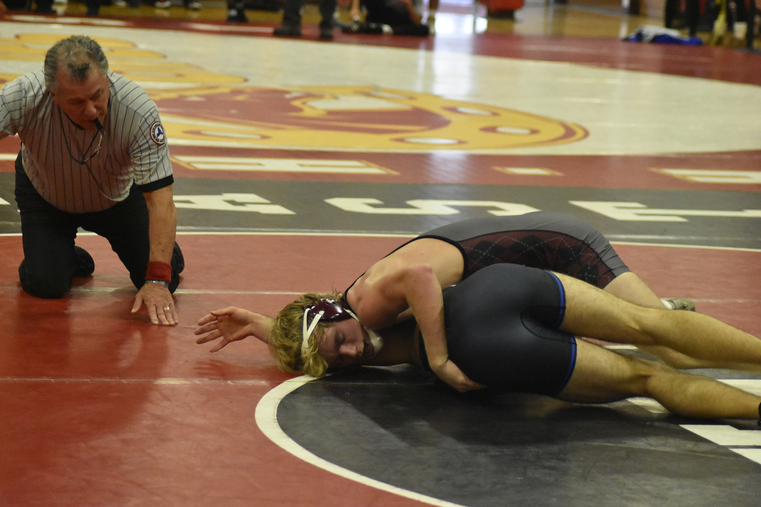 East Hampton's Adam Beckwith works on getting a pin.   DREW BUDD