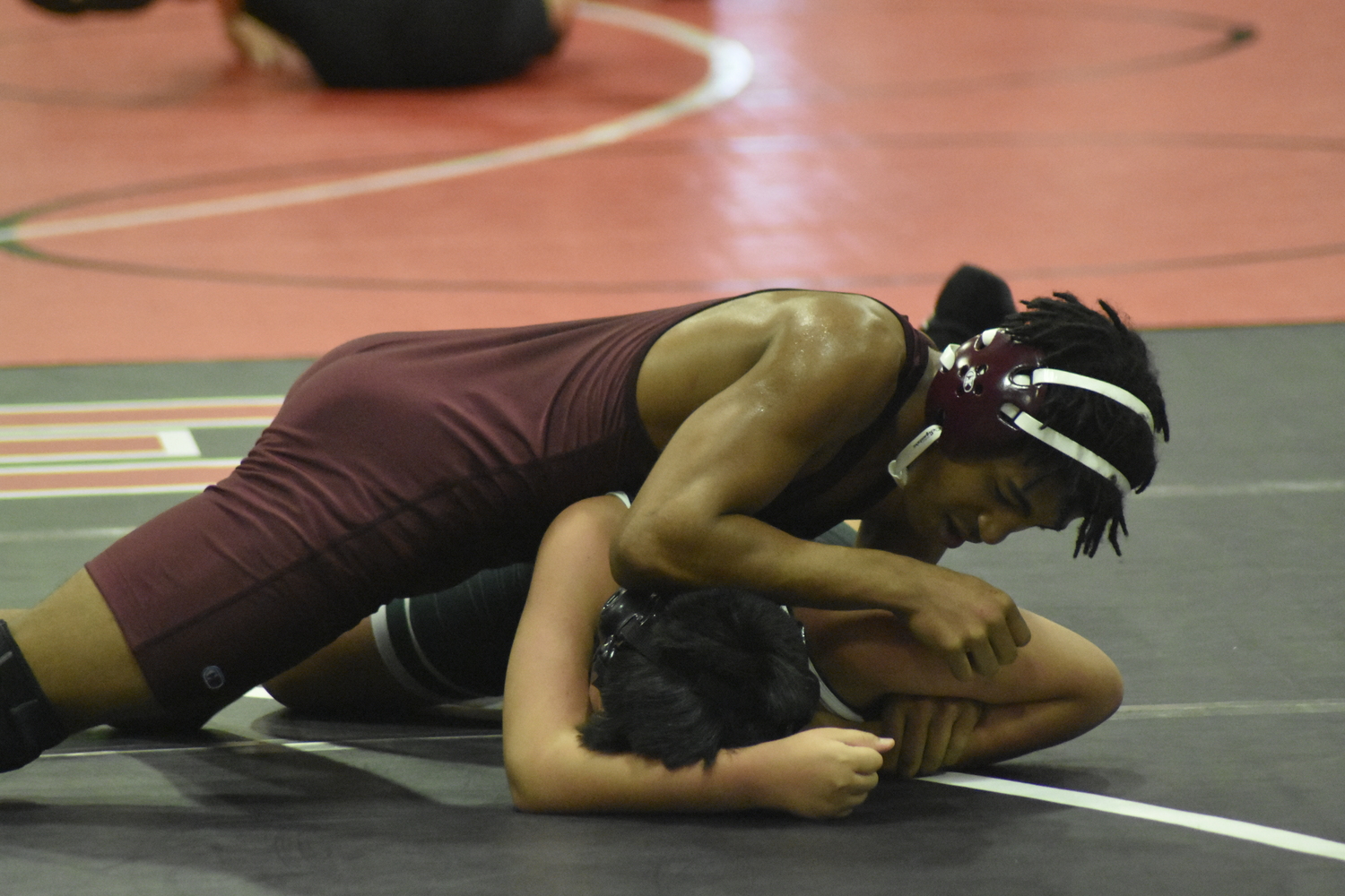 East Hampton's Marlon Garces works over his opponent at Hills East.  DREW BUDD