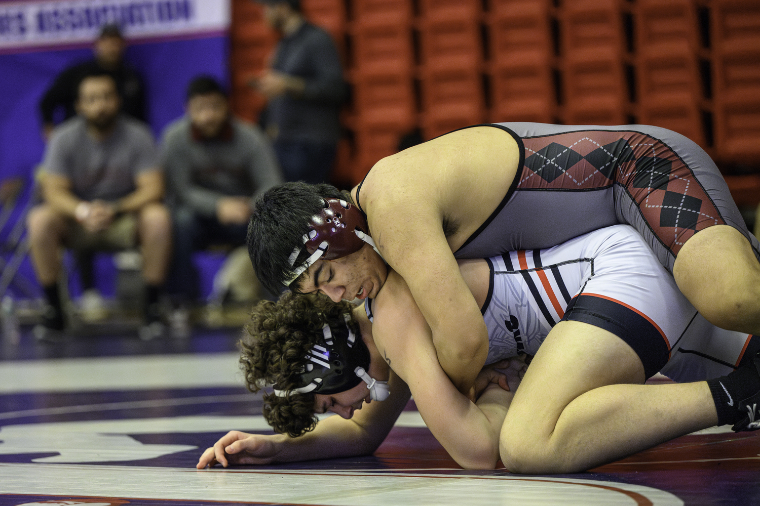 East Hampton junior Juan Espinoza working against Patchogue-Medford's Ashton Klugewicz who he pinned in the first period of the opening round on Saturday.  MARIANNE BARNETT