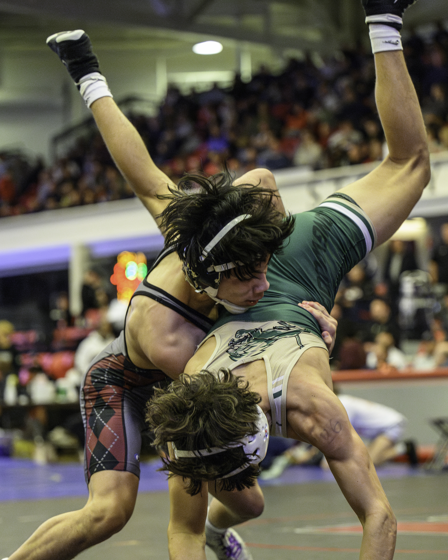 East Hampton junior Juan Roque takes down Longwood's Devin Connelly in the quarterfinals on Saturday.   MARIANNE BARNETT