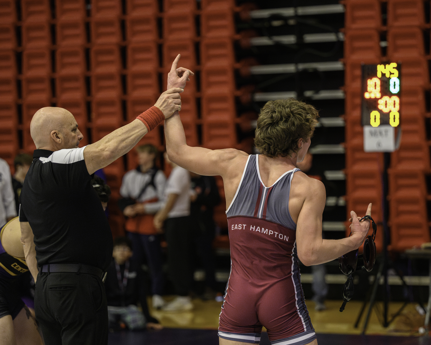 East Hampton senior Luke Castillo gets his arm raised after winning a 10-0 major decision to move on in the consolation bracket.   MARIANNE BARNETT