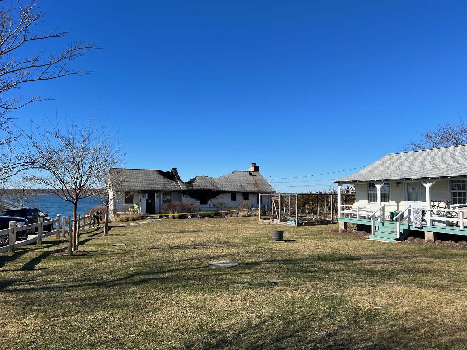 Montauk Fire Department firefighters battled a fire that badly damaged a waterfront cottage on East Lake Drive on Monday morning. Nobody was home when the fire broke out. DOUG KUNTZ