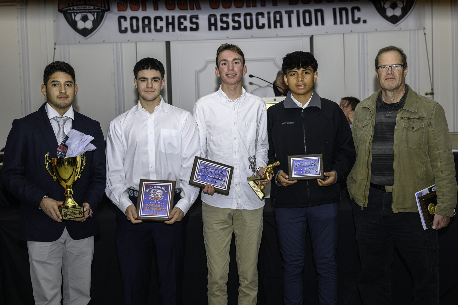 Whaler's players and coaches with their hardware.   MARIANNE BARNETT