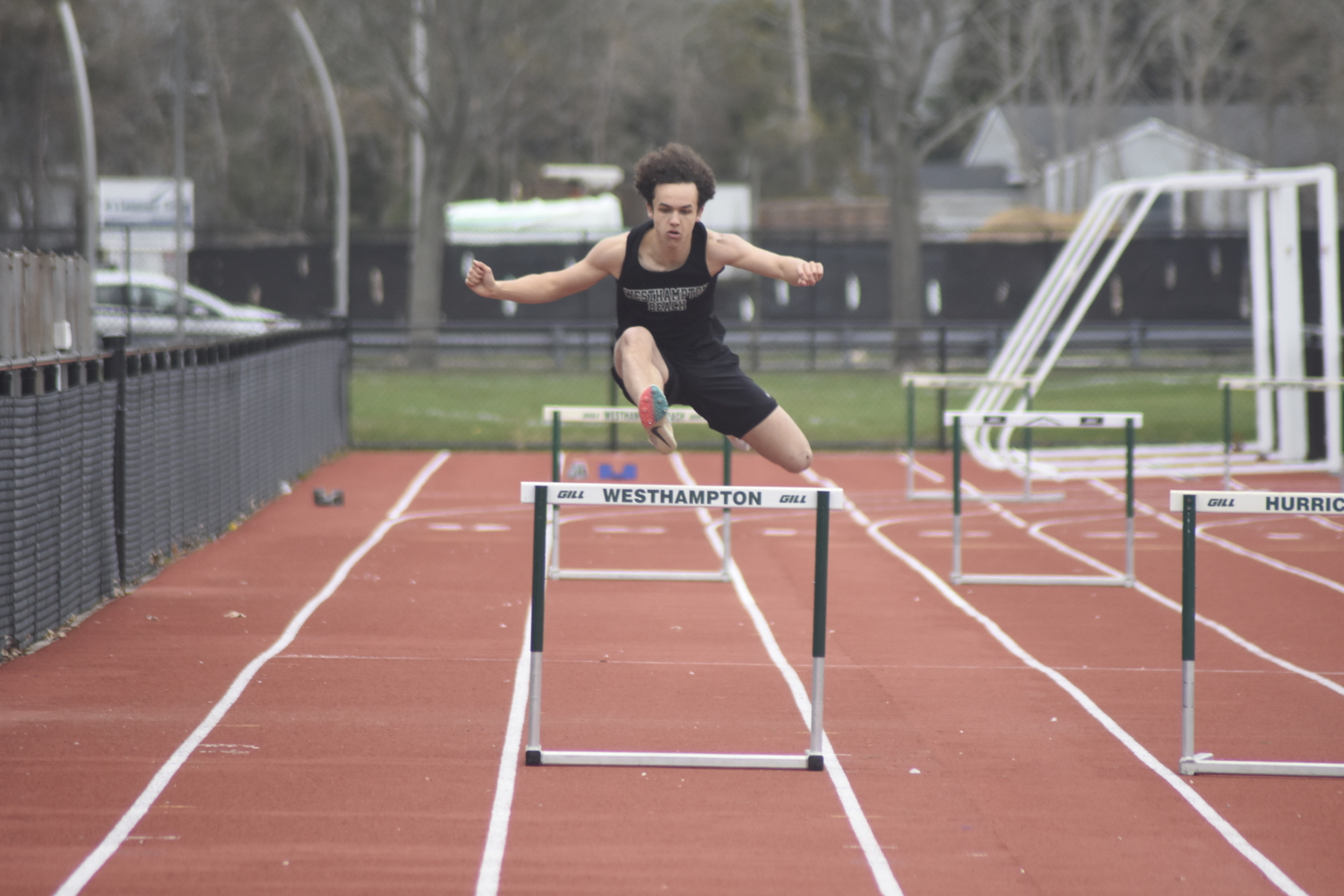 Westhampton Beach junior Ezekiel McCrary in the 400-meter intermediate hurdles.   DREW BUDD