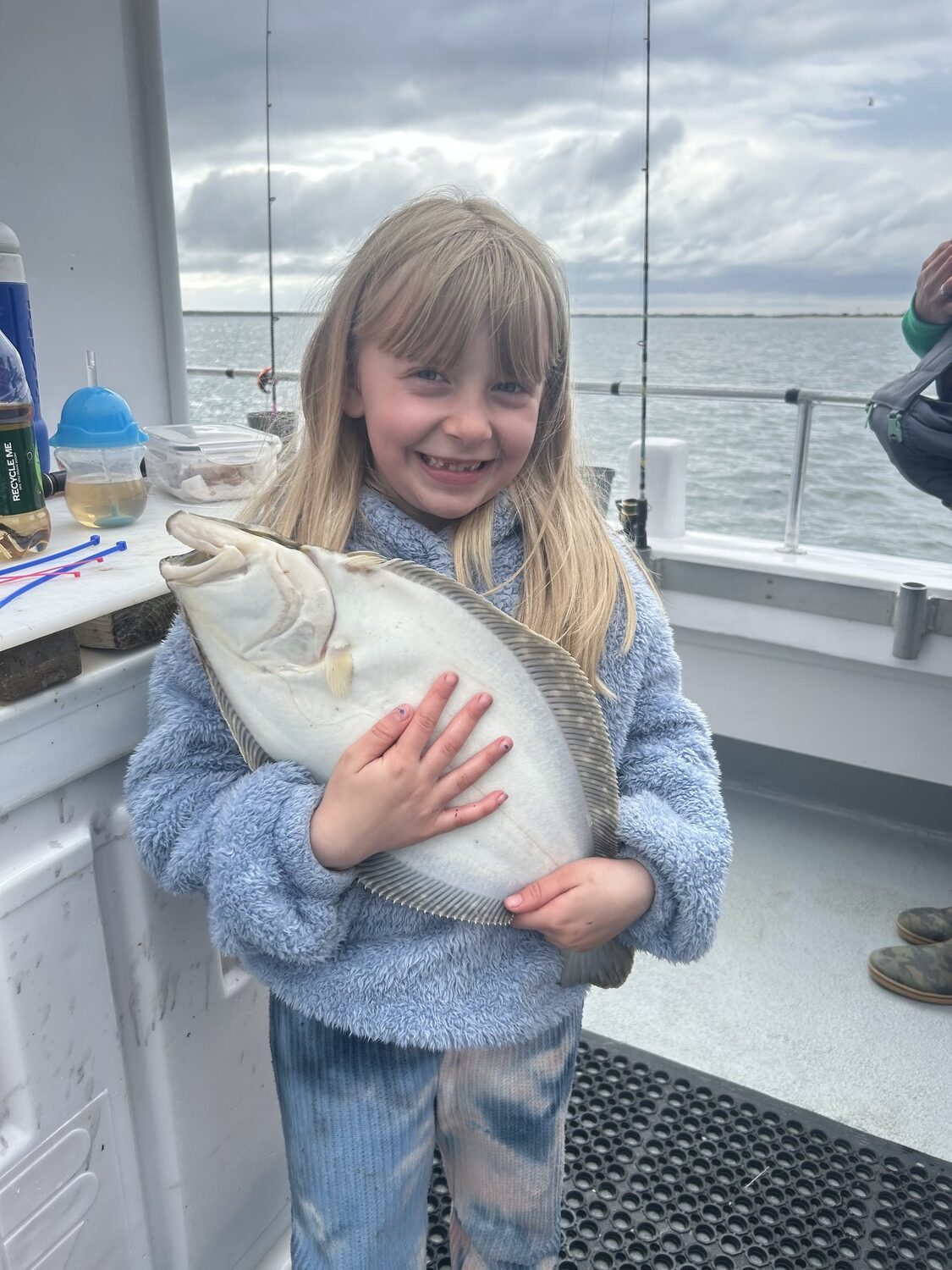 Big hugs for a big fluke from Brelynn aboard the Hampton Lady. Capt. James Foley