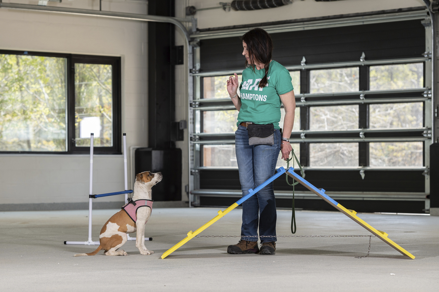 ARF Trainer Cindy LeRoy works with a puppy.       Mark Kopko Photography