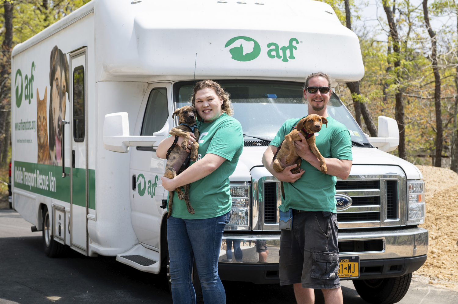 ARF’s Bridget Stonemetz and Mike Hinz rescue puppies with transport van.      Mark Kopko Photography