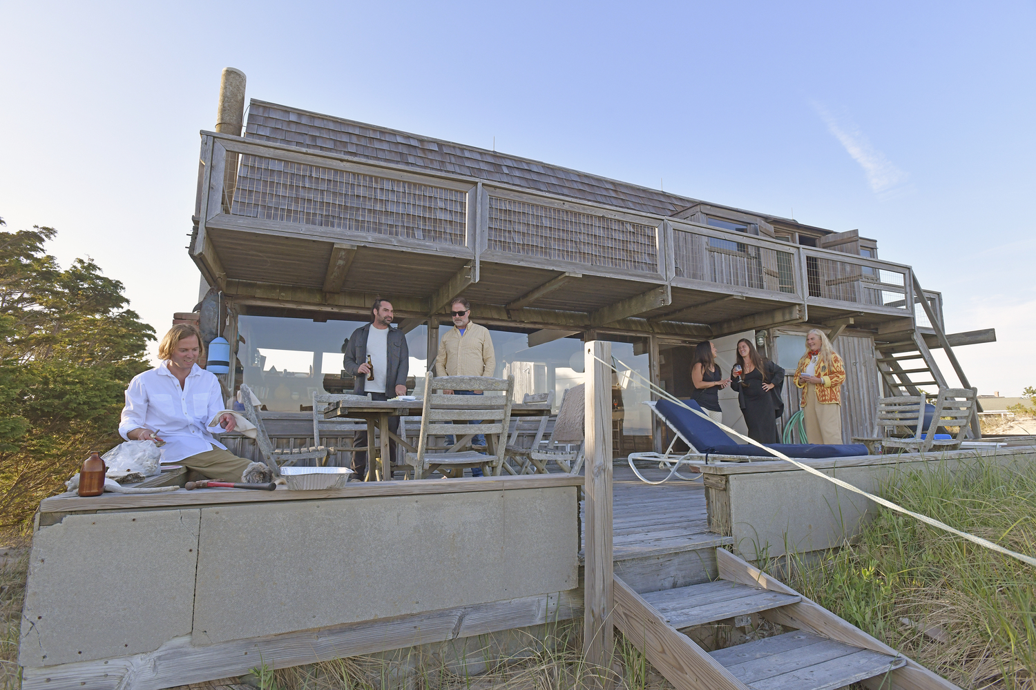 Family, friends at pets enjoy an evening on the back deck.