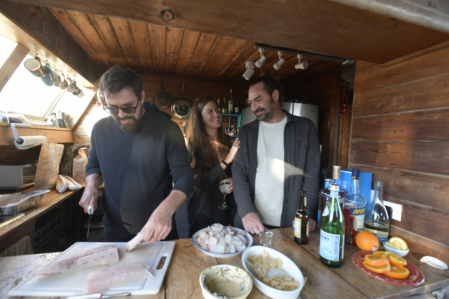 Orson Frisbie and Monica and Matt Frisbie in the kitchen.  DANA SHAW