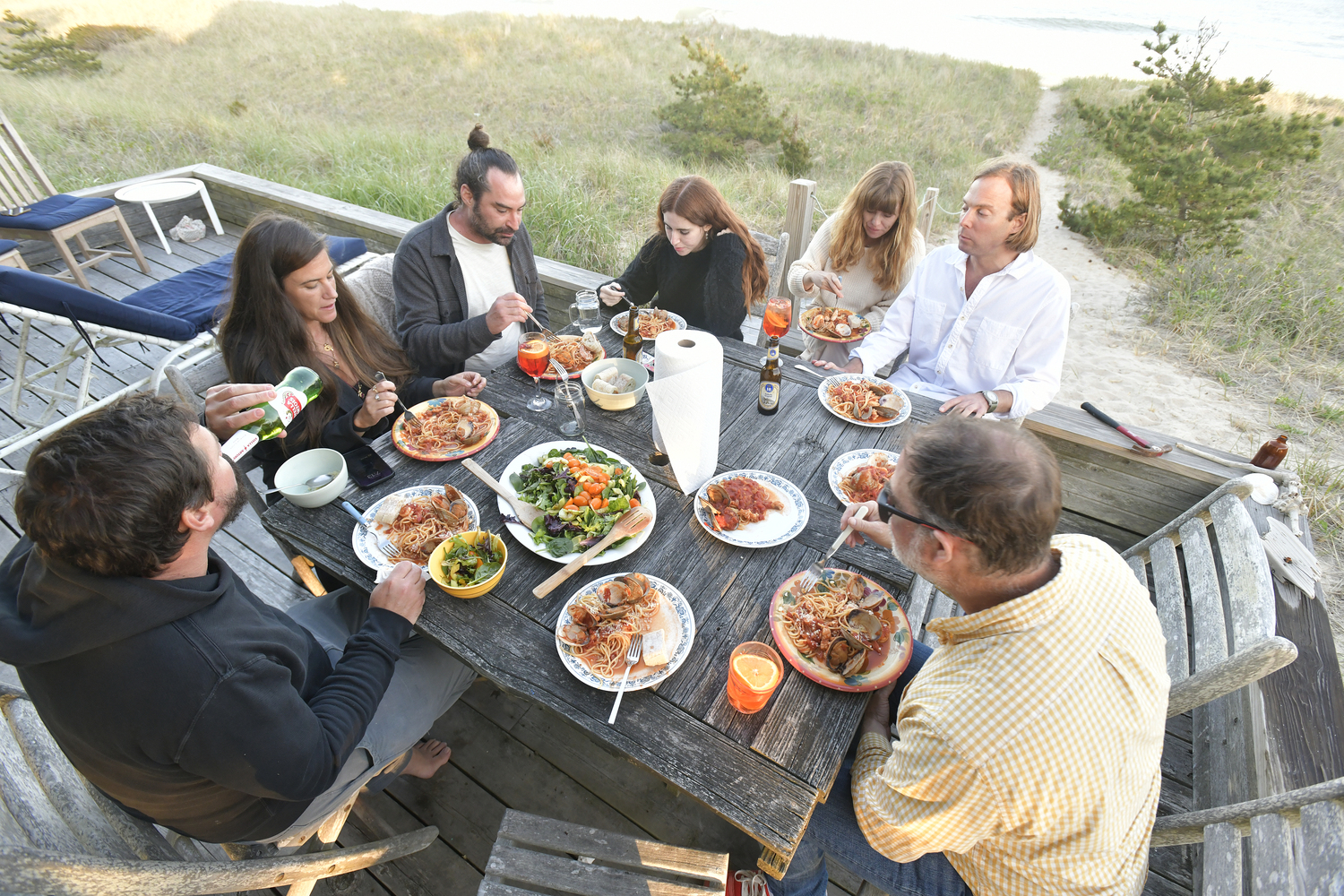 Family and friends enjoy meal on the back deck.   DANA SHAW