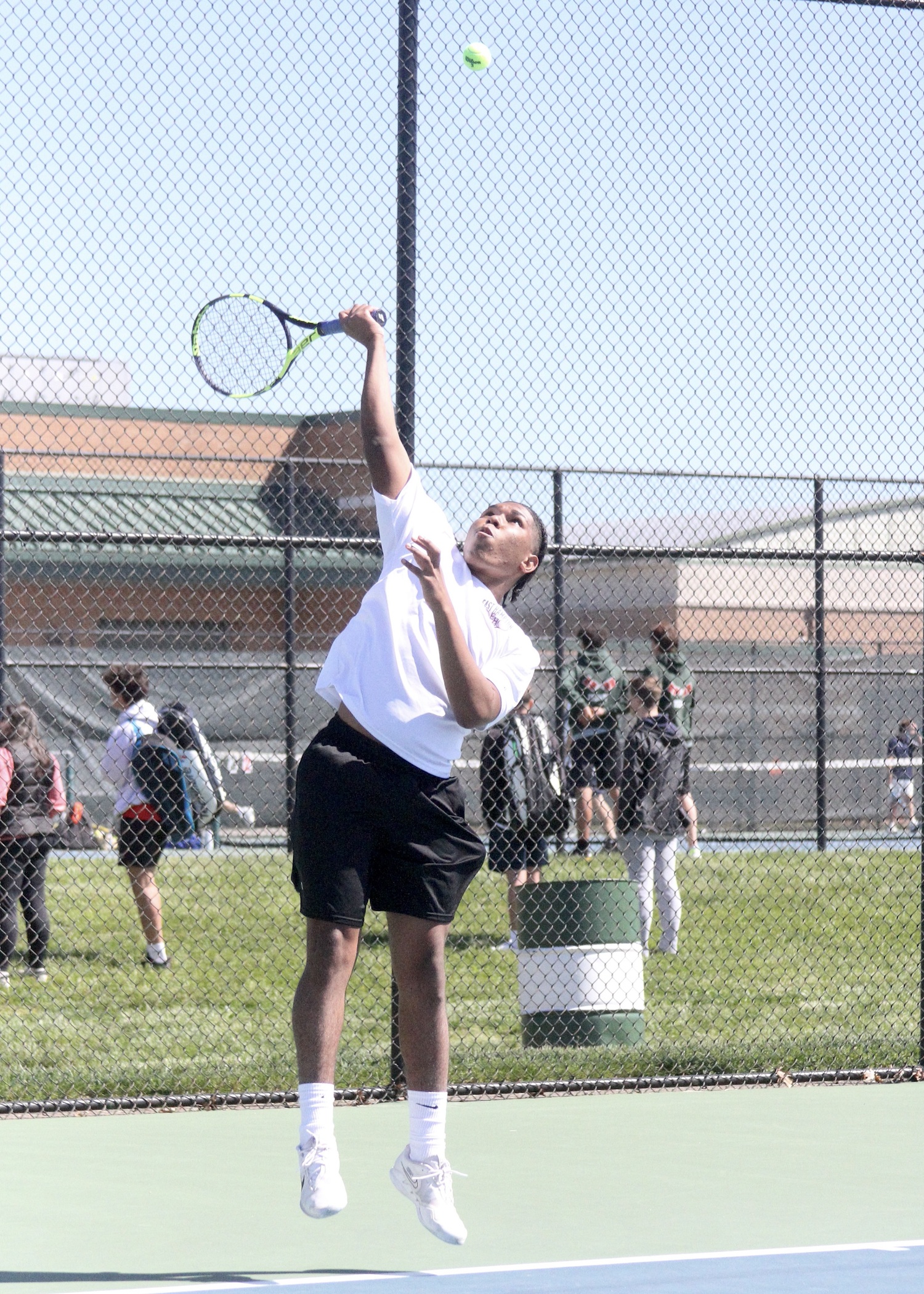 East Hampton senior Miguel Garcia serves. DESIRÉE KEEGAN