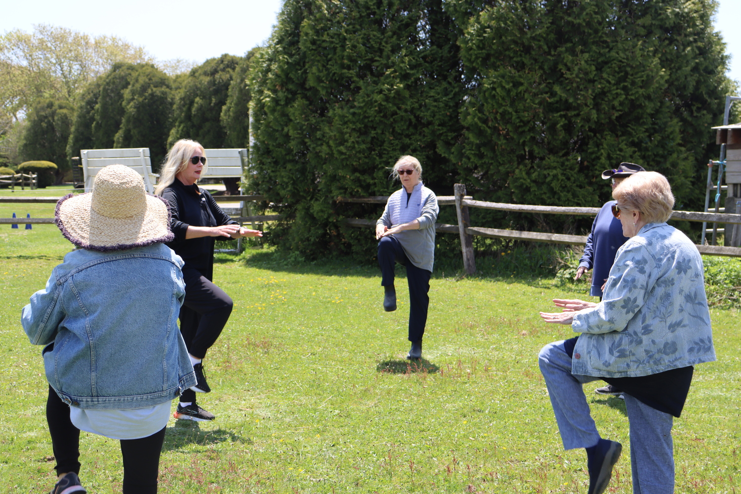 Tracie Sullivan, a cancer exercise specialist with Stony Brook Southampton Hospital, leads the women through a series of movements to warm up before they being grooming the horses. CAILIN RILEY