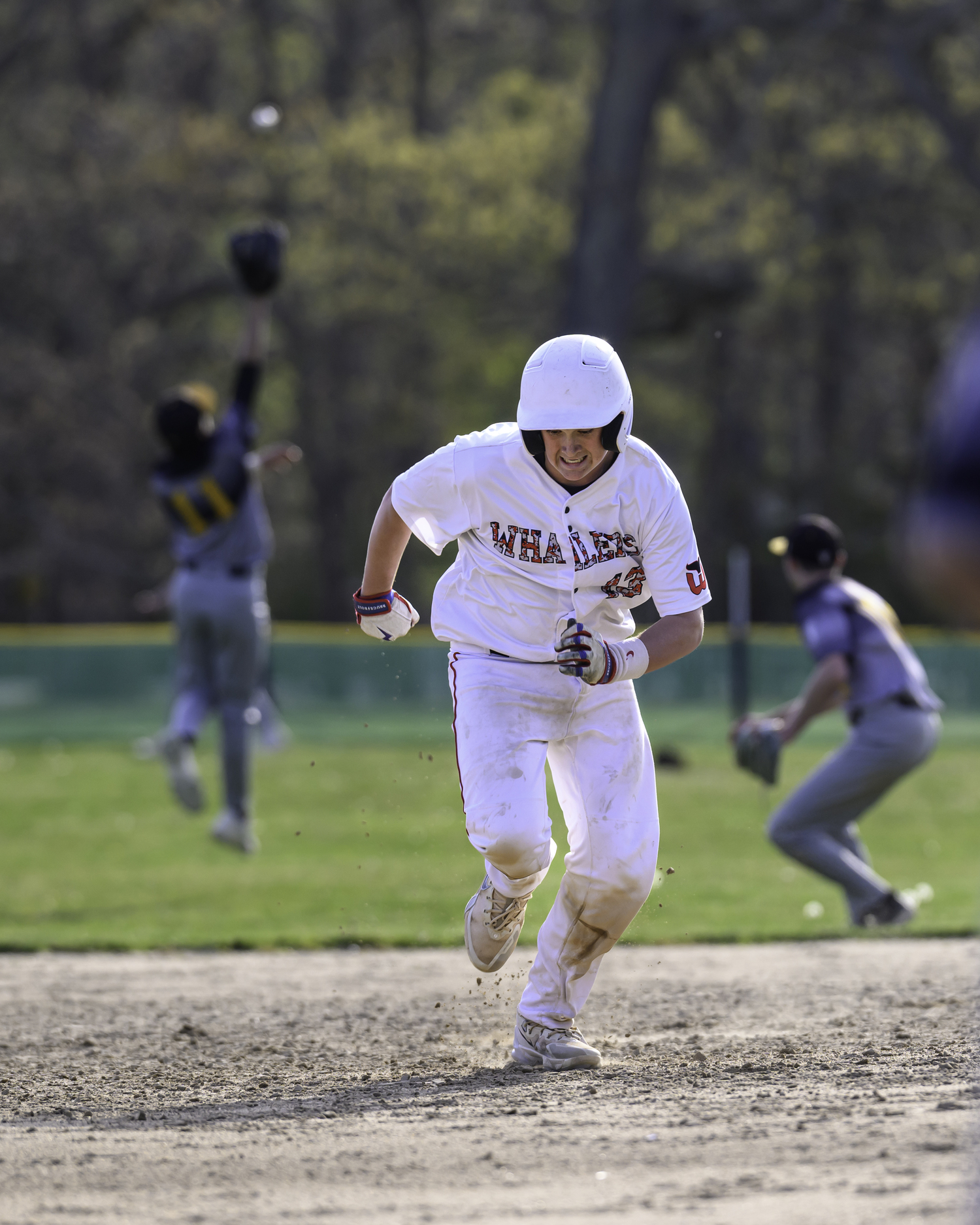 Pierson's Jeffrey Gregor hustles to third base with the throw coming back to the infield.   MARIANNE BARNETT