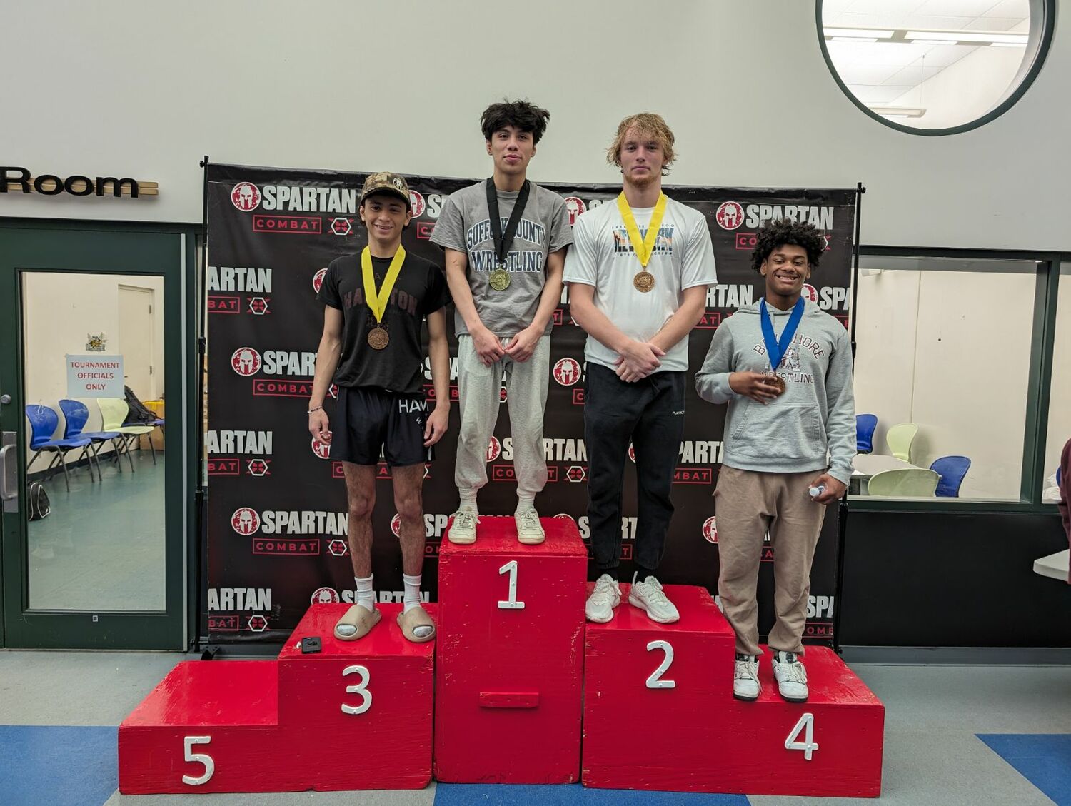 Juan Roque standing atop the podium at the New York State Greco-Roman Championships.   COURTESY ETHAN MITCHELL