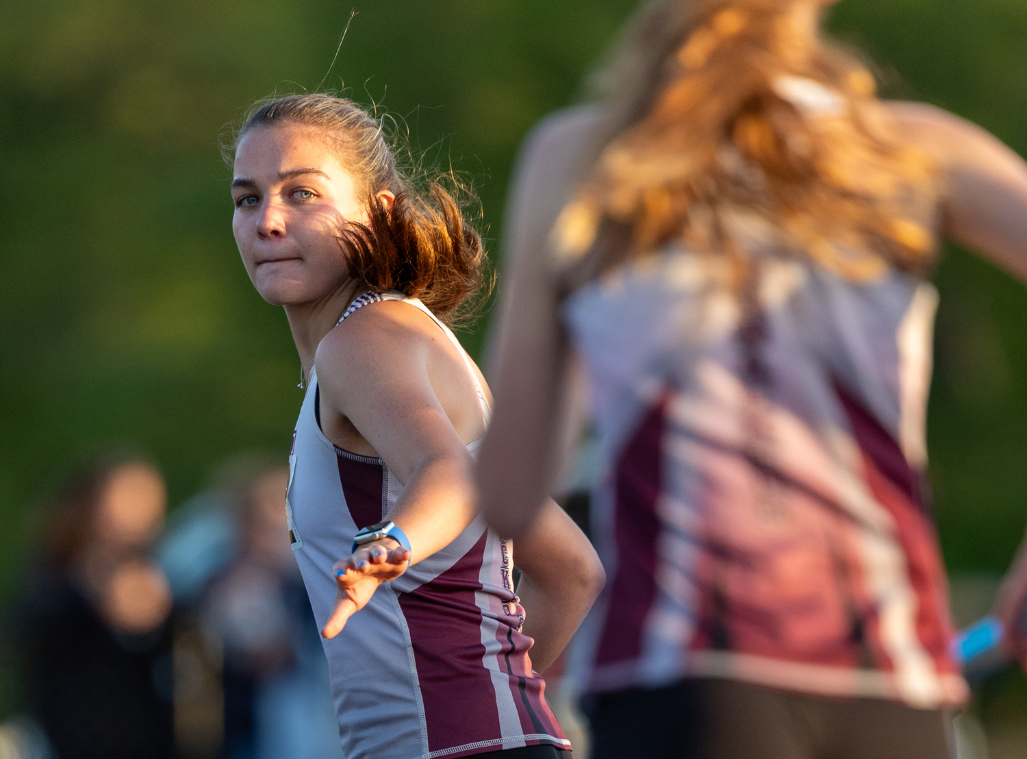 Greylynn Guyer is ready to take the baton from incoming relay mate Sara O'Brien.  RON ESPOSITO