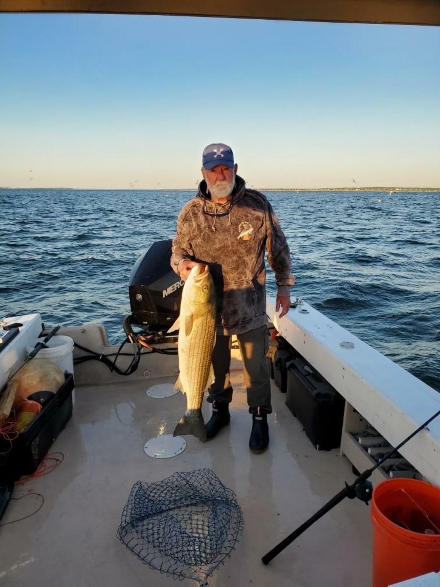 Al Daniels with a large striped bass he caught.   COURTESY SUE DANIELS