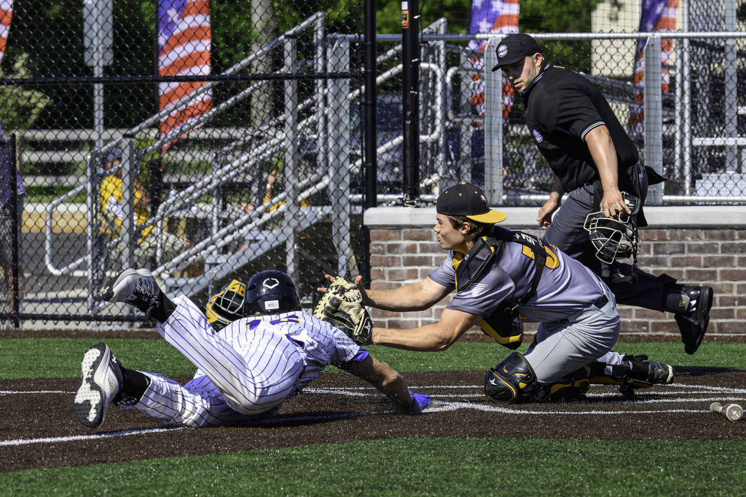 Ross senior Milo Tompkins makes a play at home for the out. MARIANNE BARNETT