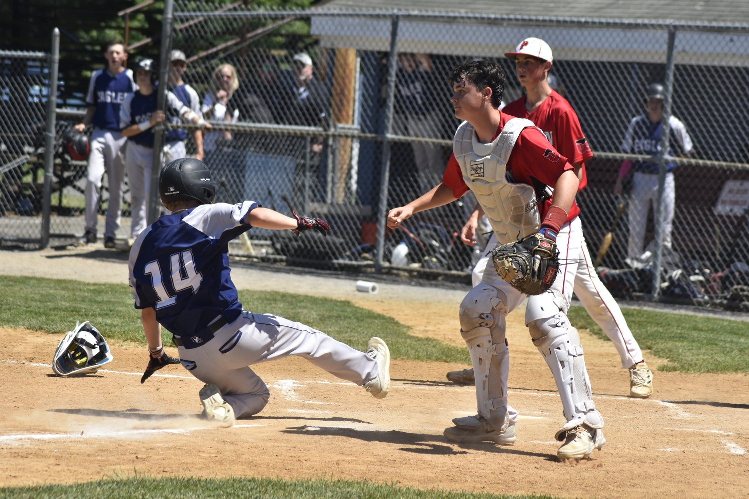 A Burke Catholic player scores on a sacrifice fly.  DREW BUDD