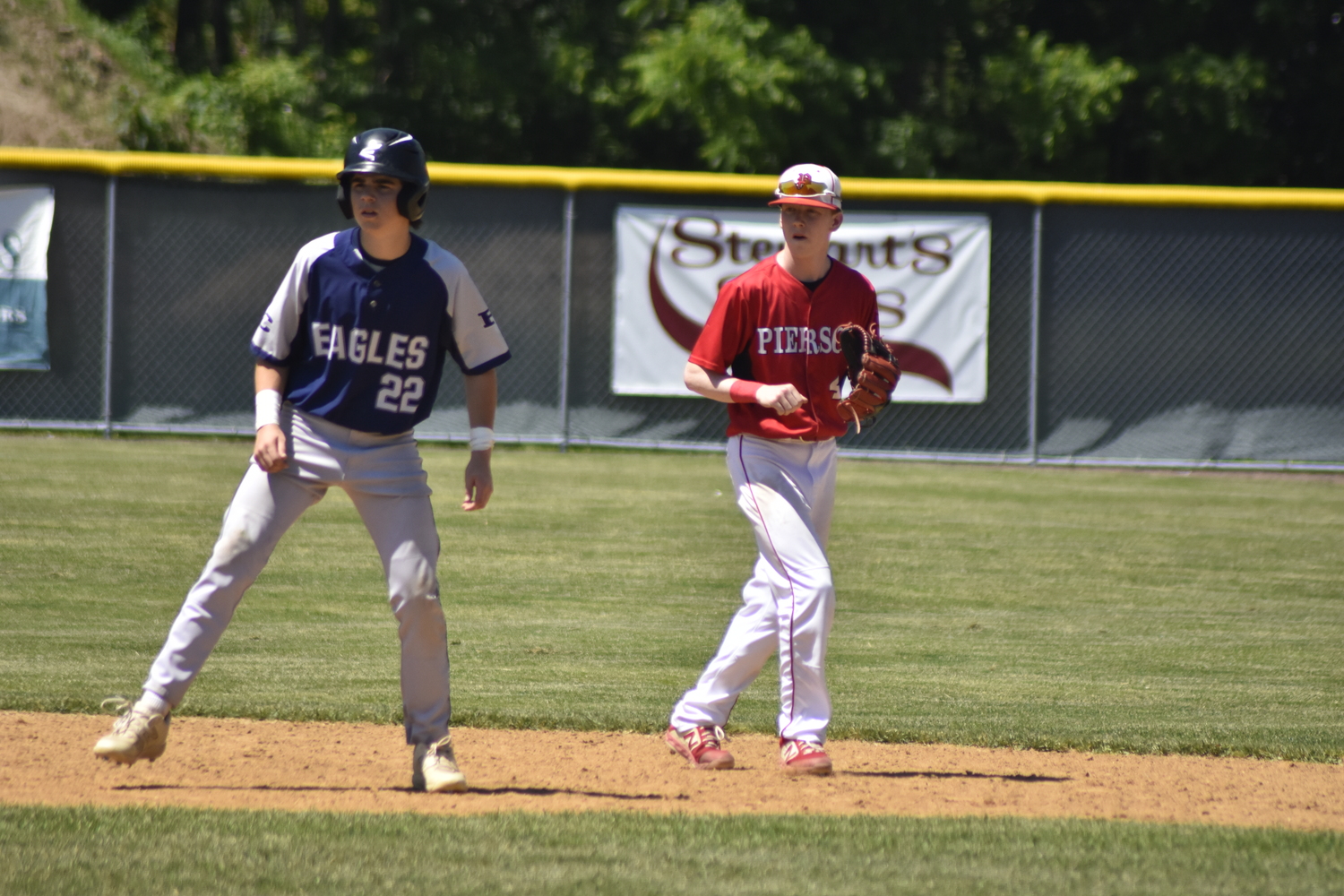 Pierson shortstop Spencer Cavaniola holds a Burke Catholic base runner on at second base.  DREW BUDD