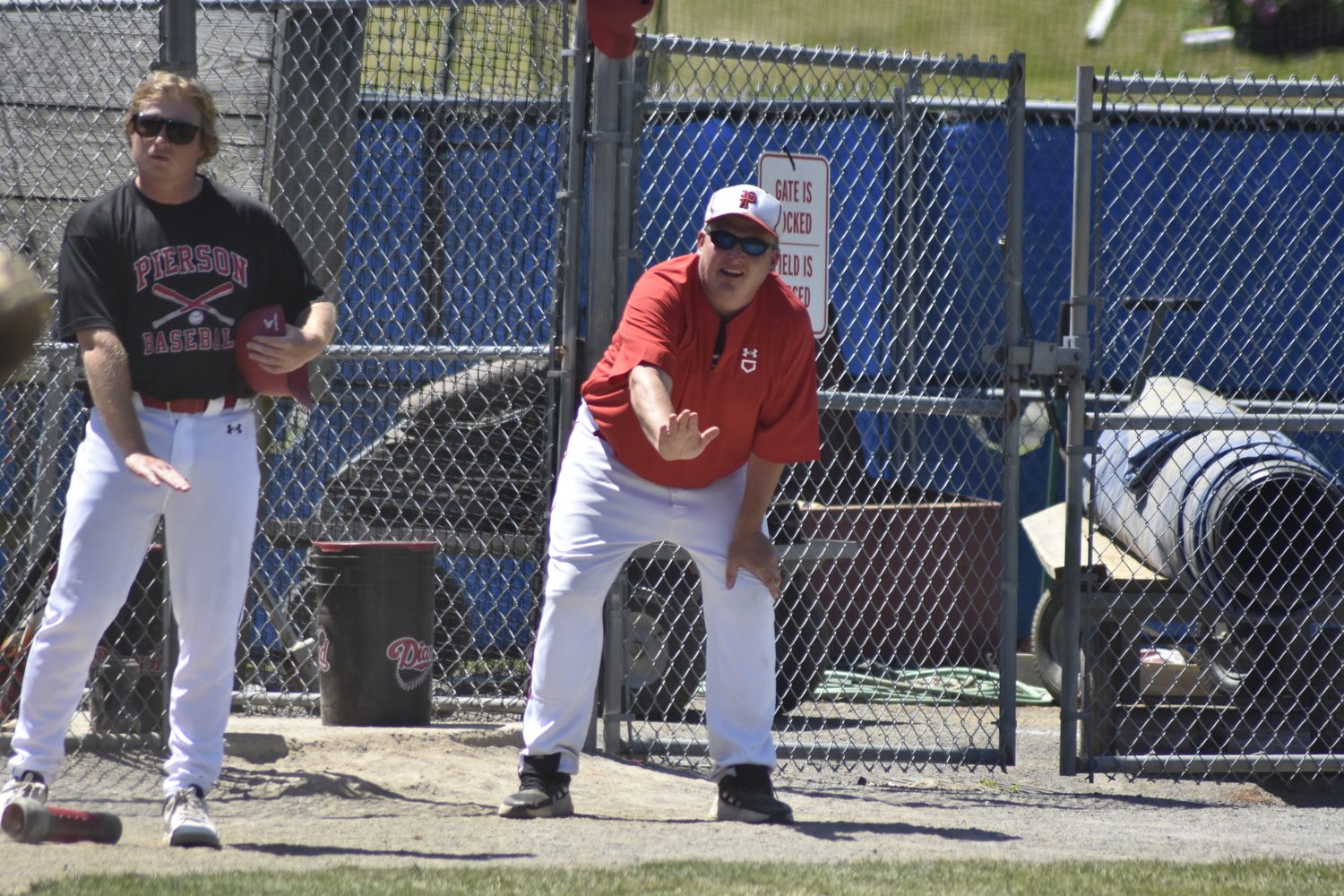 Assistant coach Matt Heffernan, left, and Pierson head coach Bob Manning asks the home plate umpire of the previous pitch location.  DREW BUDD