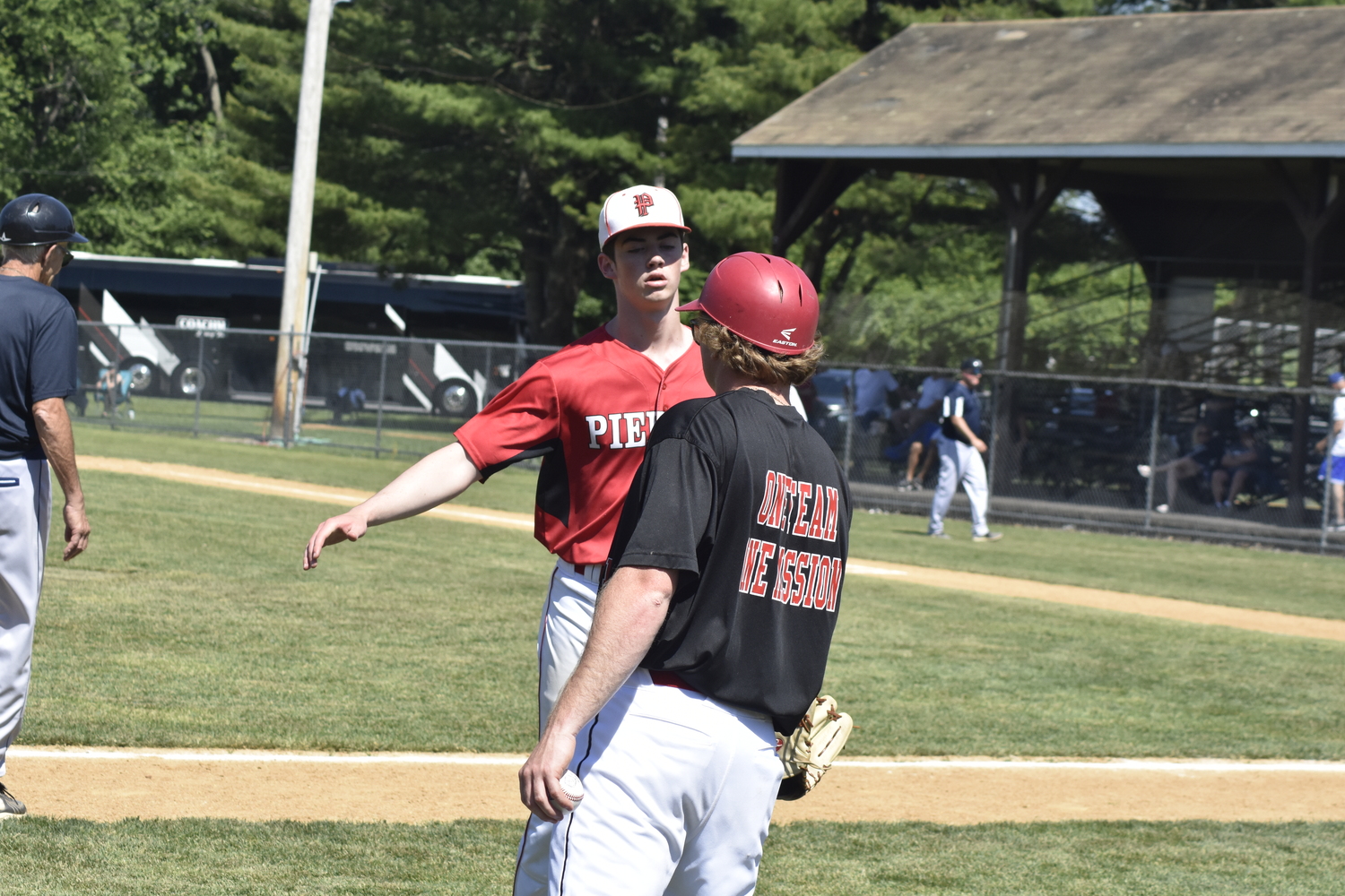 Nathan Dee is congratulated by assistant coach Matt Heffernan for getting himself out of a jam.  DREW BUDD