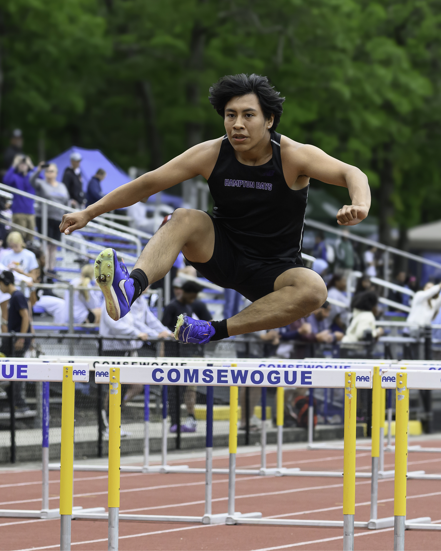 Hampton Bays senior Brian DeJesus running in the 110-meter high hurdles of the pentathlon.   MARIANNE BARNETT