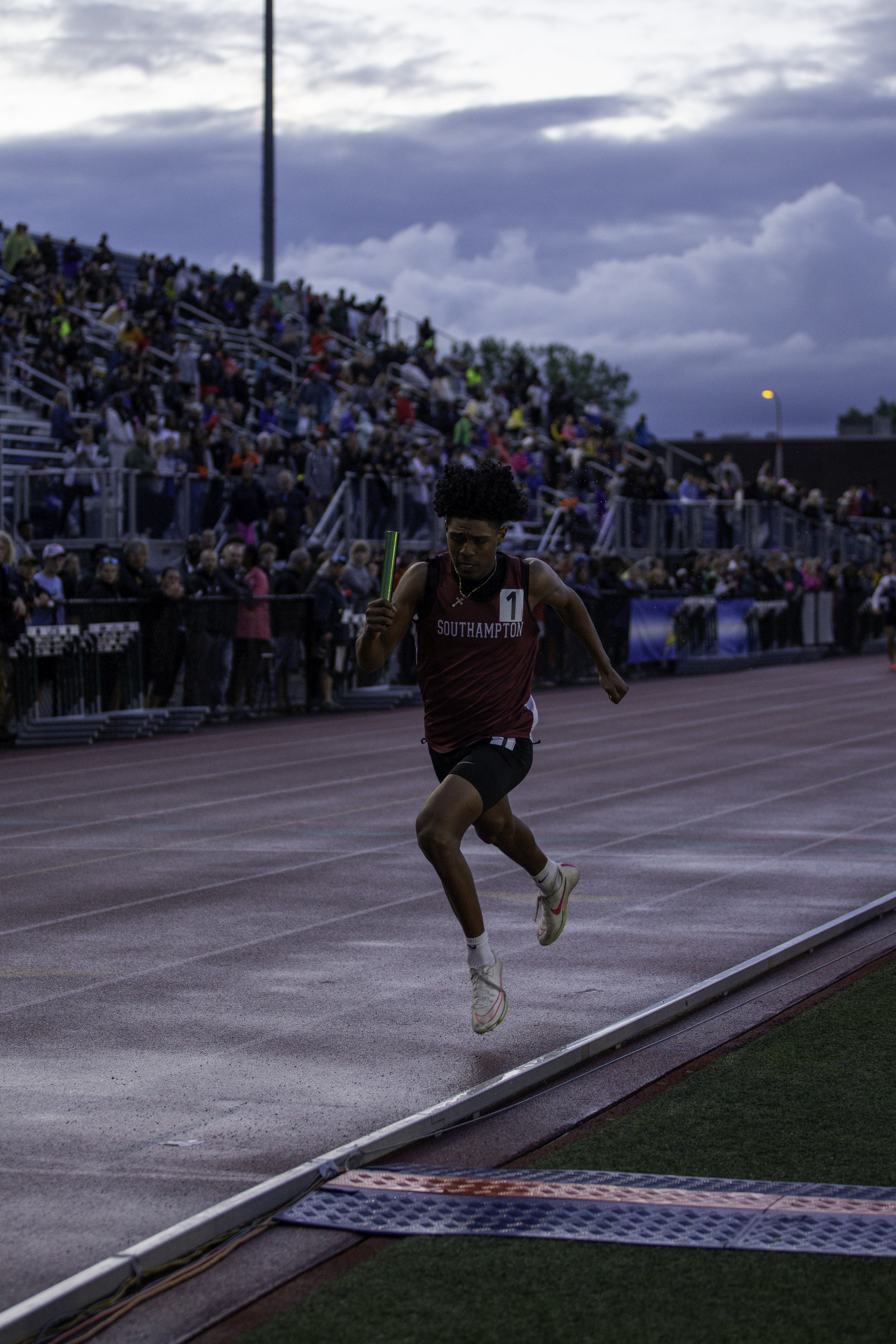 Senior Dominick White finishes the 4x100-meter relay for the Mariners.   ZAIDA TALEV