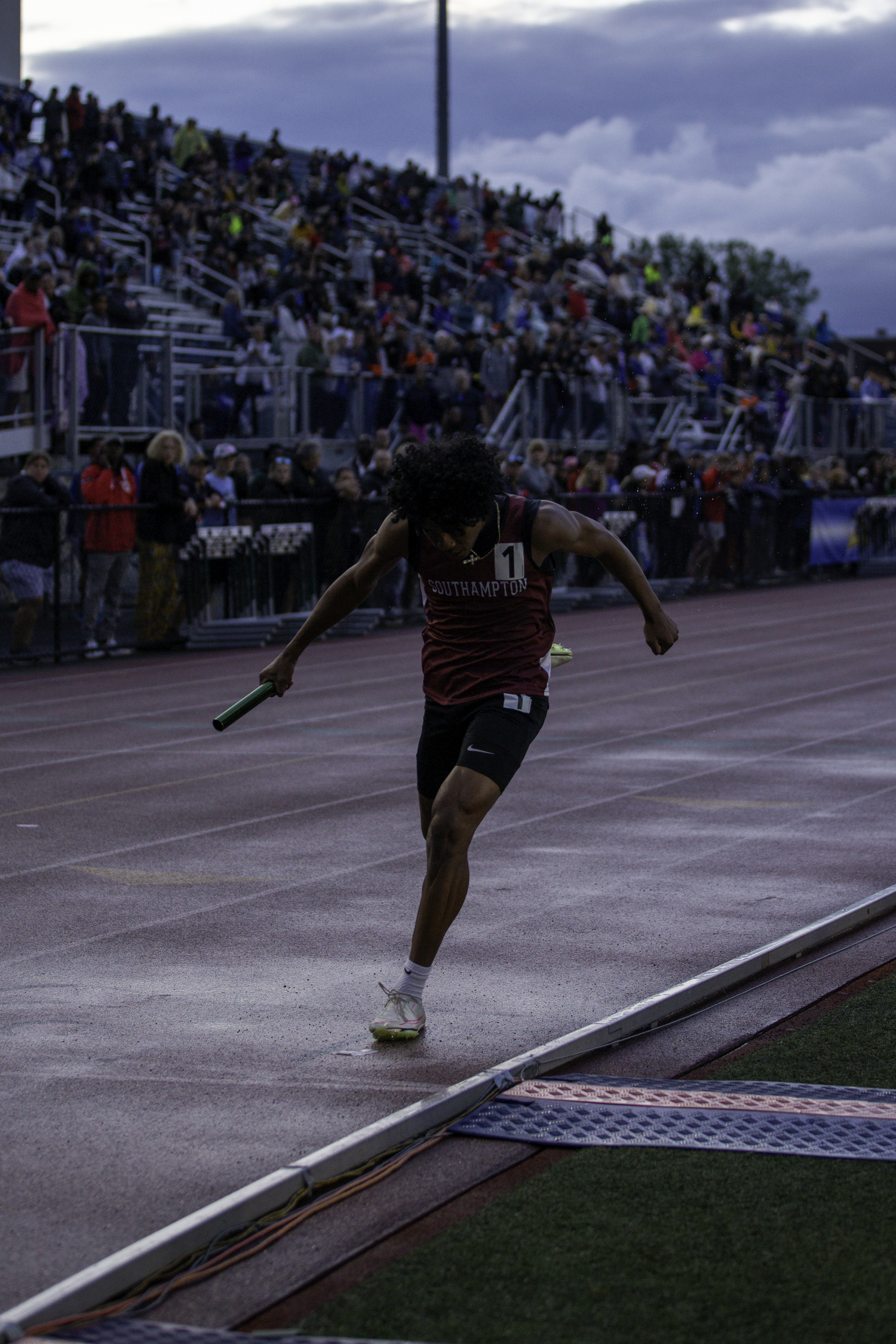 Senior Dominick White finishes the 4x100-meter relay for the Mariners.   ZAIDA TALEV