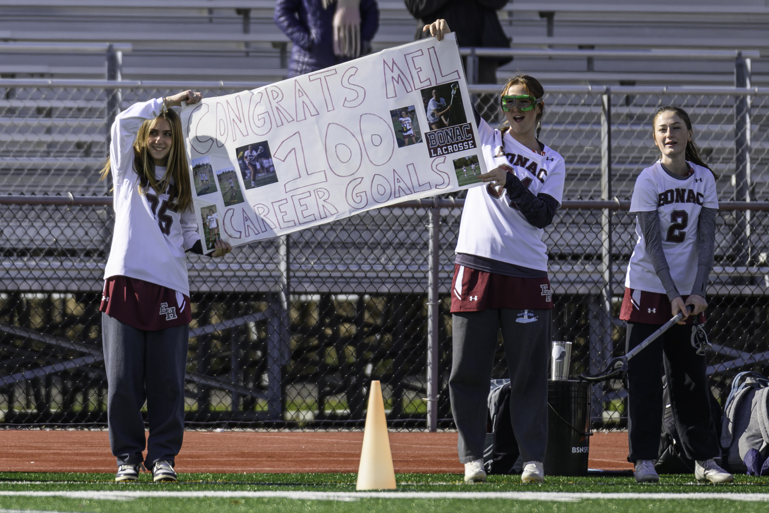 Bonac teammates hold up a sign marking Melina Sarlo's 100th career goal this past spring.   MARIANNE BARNETT