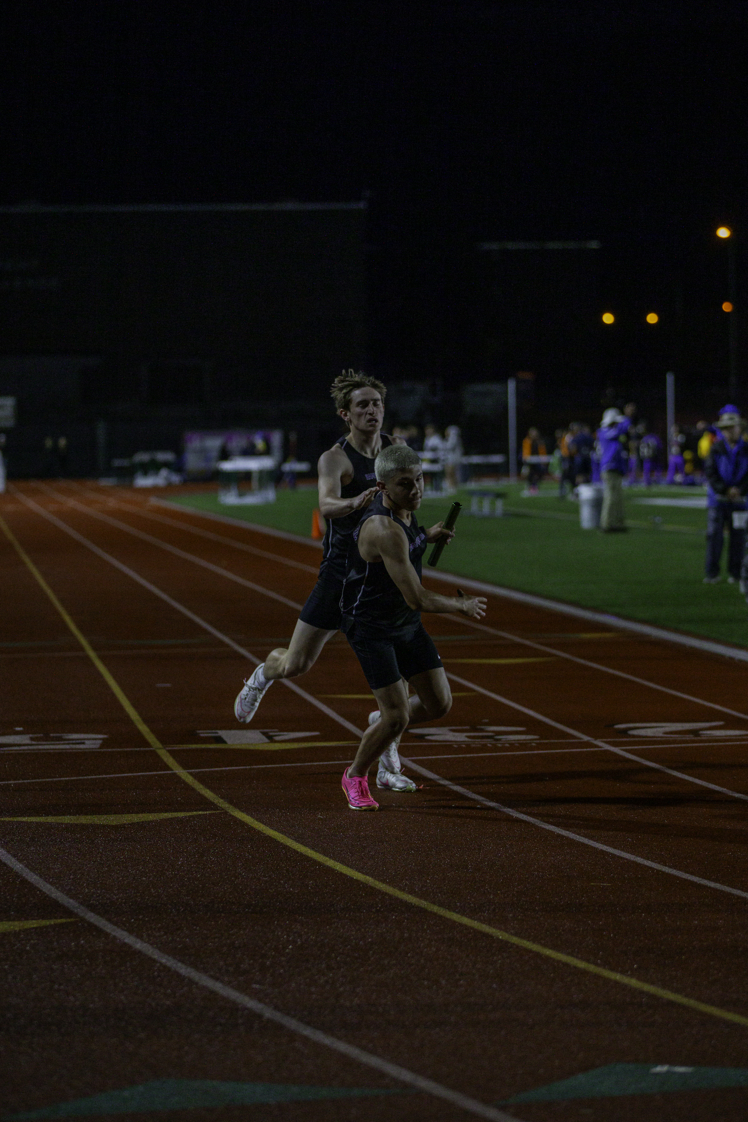 Matthew Papajohn hands off to Daniel Ortiz in the 4x400-meter relay.   ZAIDA TALEV