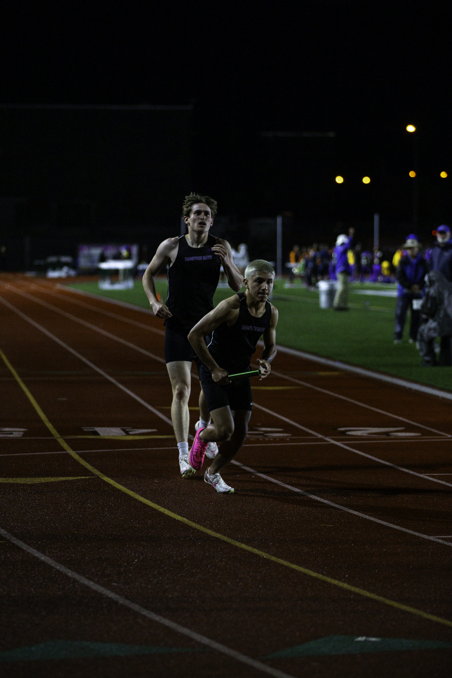 Matthew Papajohn hands off to Daniel Ortiz in the 4x400-meter relay.   ZAIDA TALEV