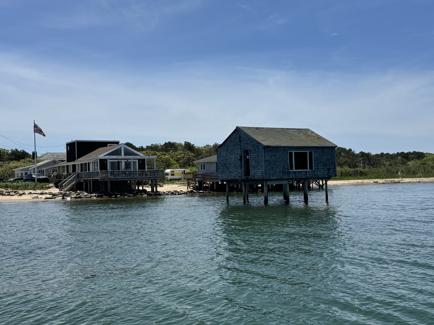 The area of Lazy Point is one of the most erosion prone regions of the town, thanks to decades old manmade structures and the digging of a new inlet to Napeague Harbor, that have interrupted the natural flow of sand along the shoreline, experts say. A house at the end of Mulford Lane, just a few hundred yards east of the Bay View Avenue homes, has been completedly undermined and its abandoned skeleton sits permanently perched above the waters of Gardiners Bay. MICHAEL WRIGHT