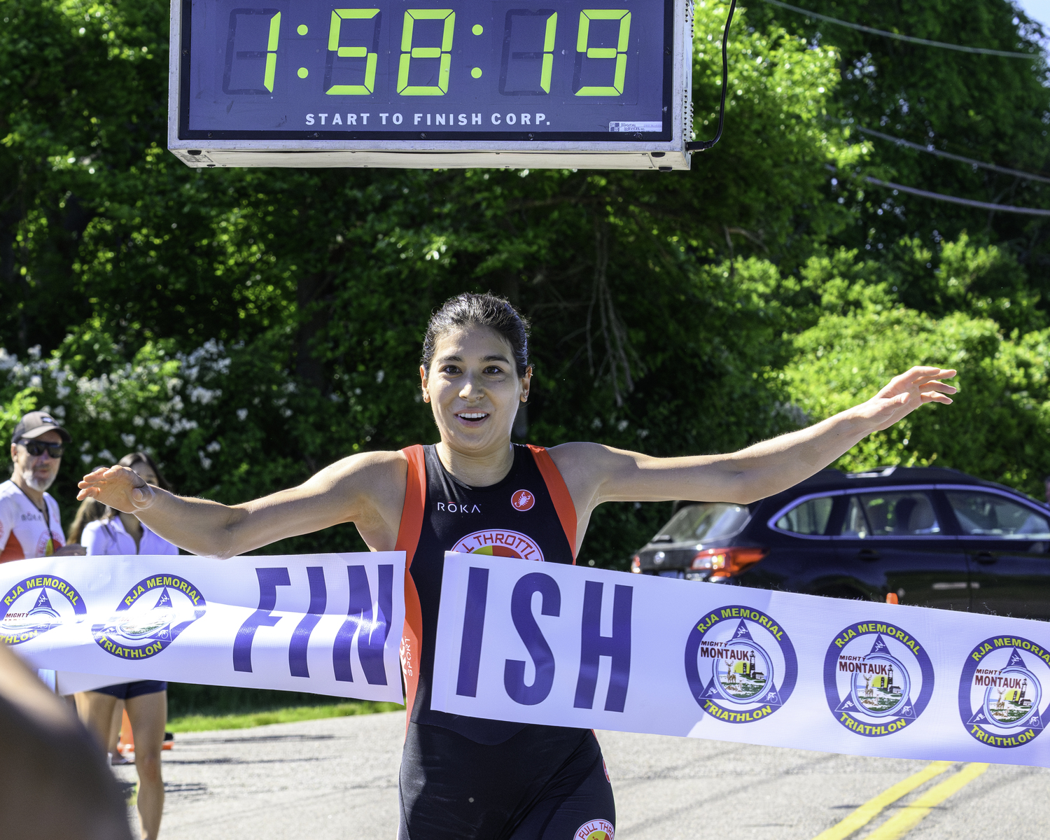 Jillian Jacinth crosses the finish line as the women's champion of the full triathlon.   MARIANNE BARNETT