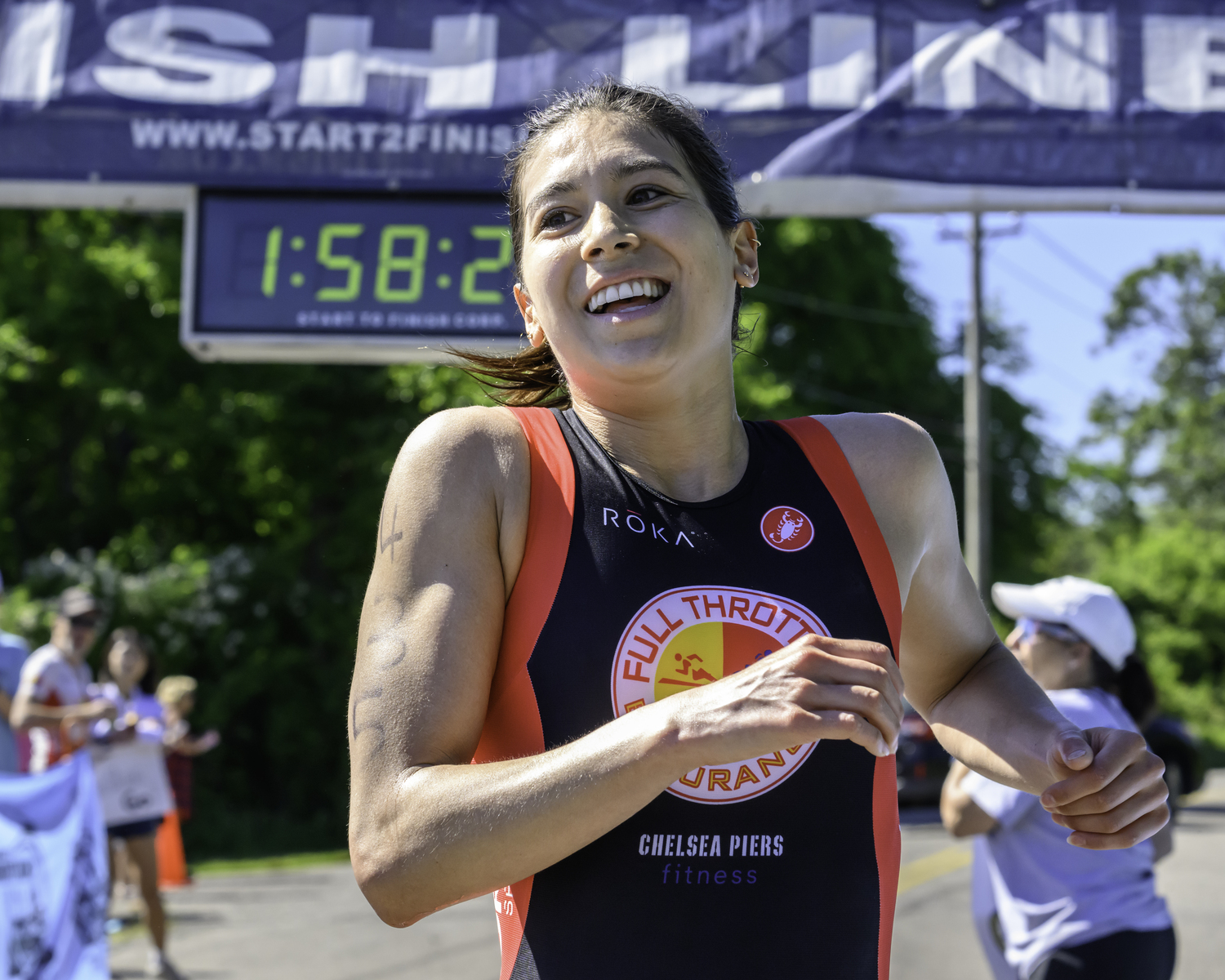 Jillian Jacinth crosses the finish line as the women's champion of the full triathlon.   MARIANNE BARNETT