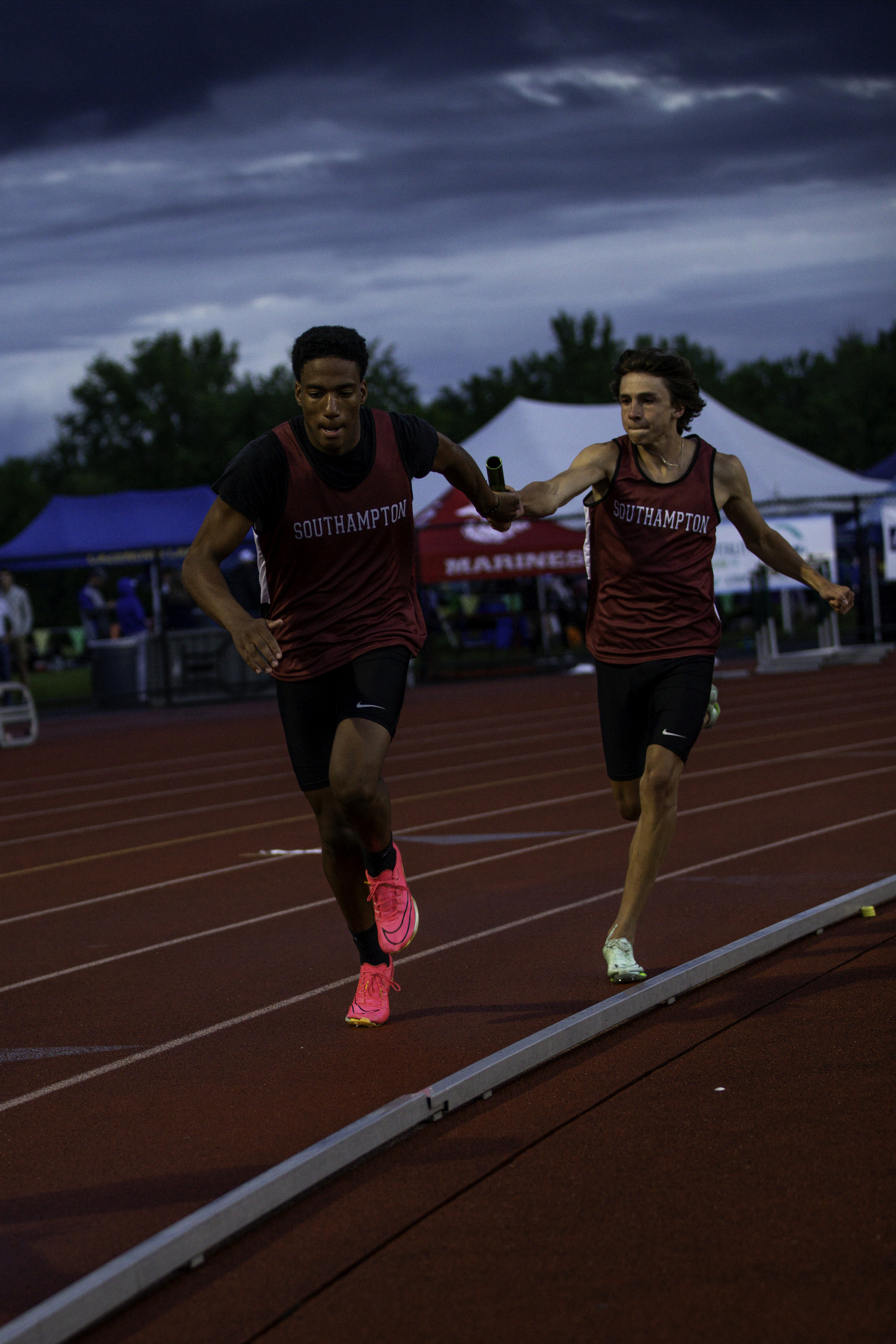 Davon Palmore takes the baton from Tanner Marro in the 4x100-meter relay.   ZAIDA TALEV