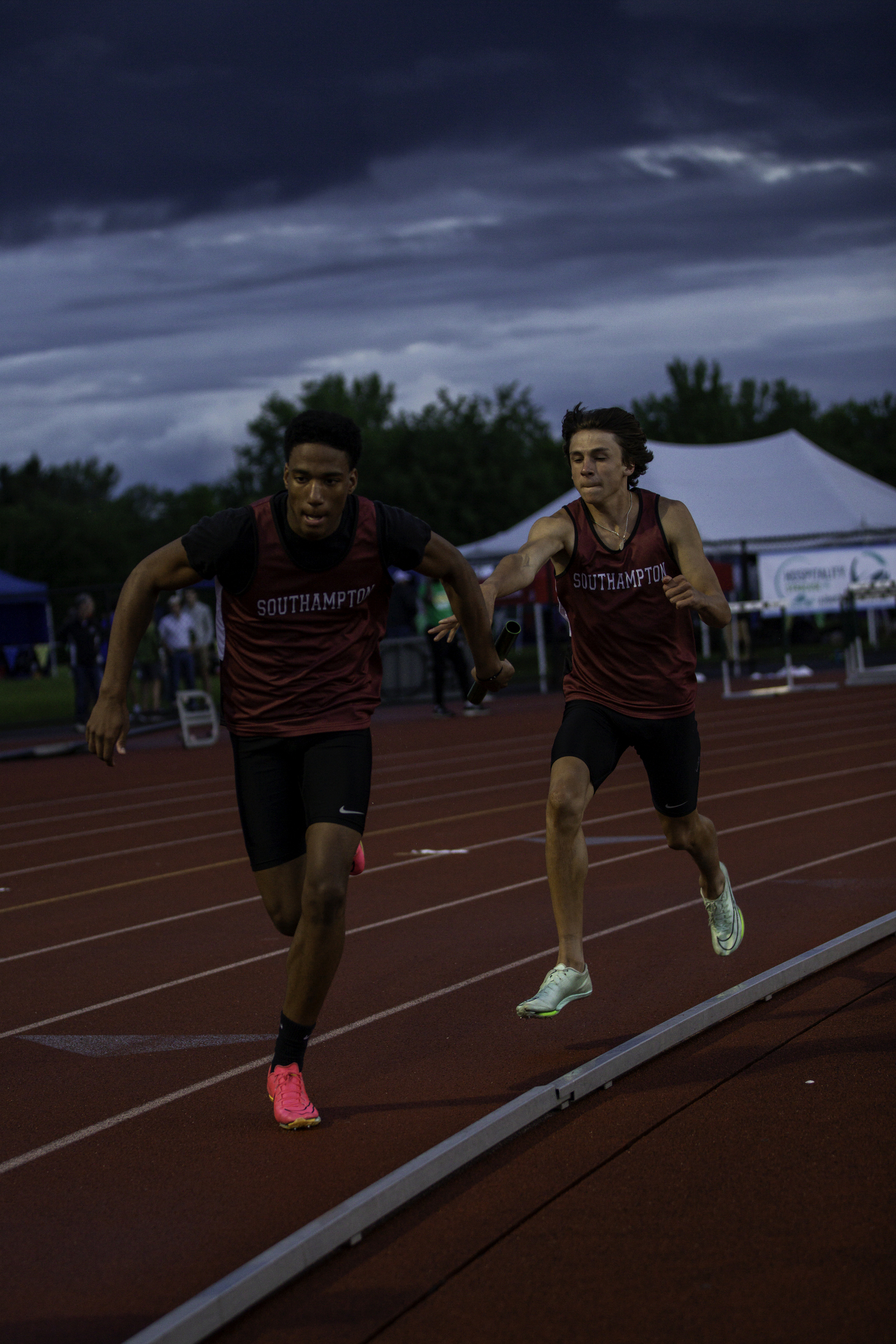 Tanner Marro hands the baton off to Davon Palmore in the 4x100-meter relay.   ZAIDA TALEV