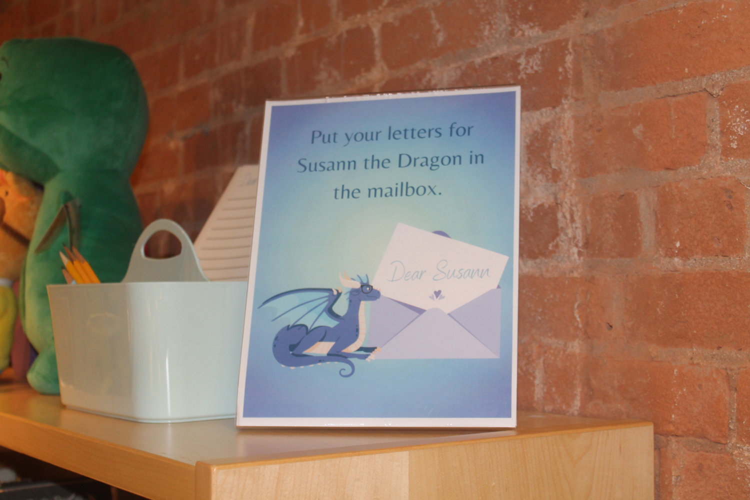 A welcoming sign for kids to write letters to Susann the Dragon. HOPE HAMILTON